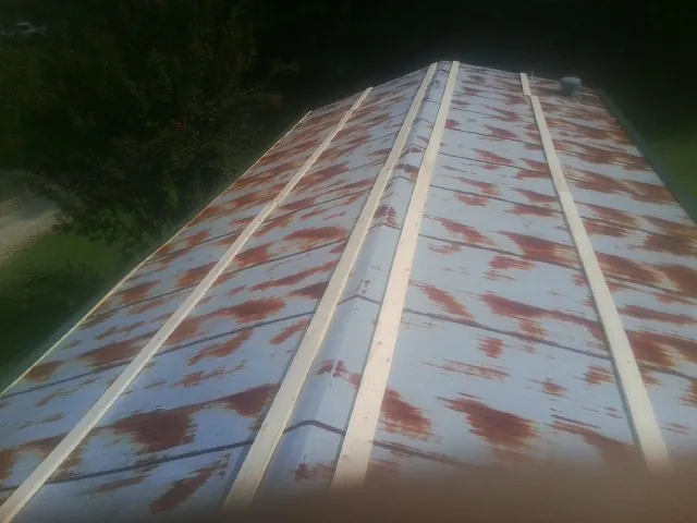 Rusted metal roof panels with new wood purlins before replacement — Storm Damage Roof Repair in West Chicago by Roofing Brothers