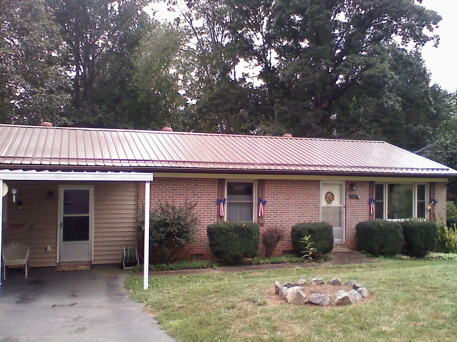 Bronze metal roof and carport on a brick ranch home — Roof Repair work by our crew in West Chicago