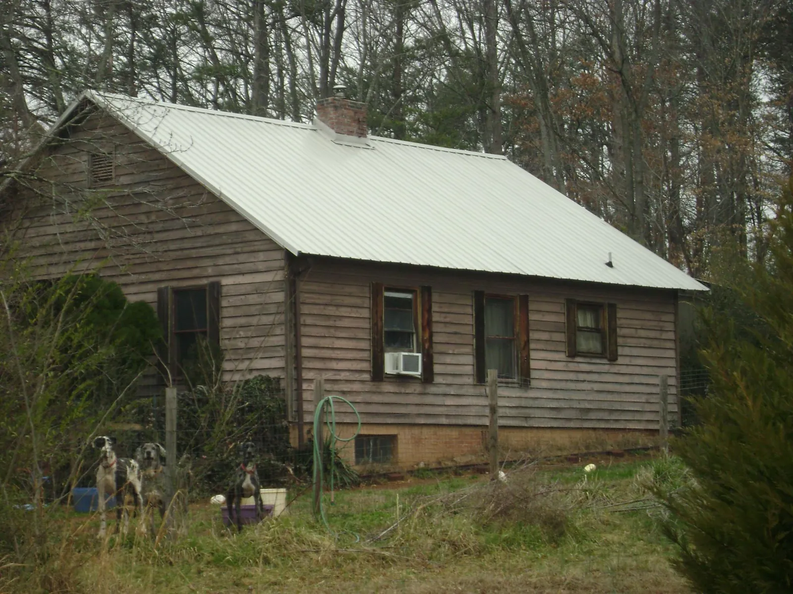 White metal roof on an old wood sided farmhouse, from a Metal Roof Installation job in West Chicago